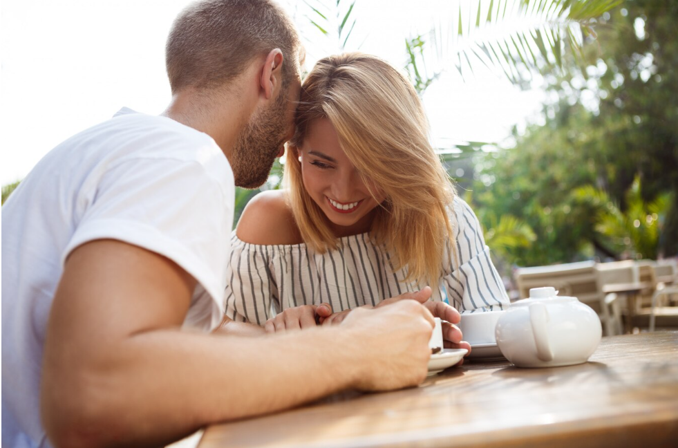 couple qui discute autour d'un café rigolant